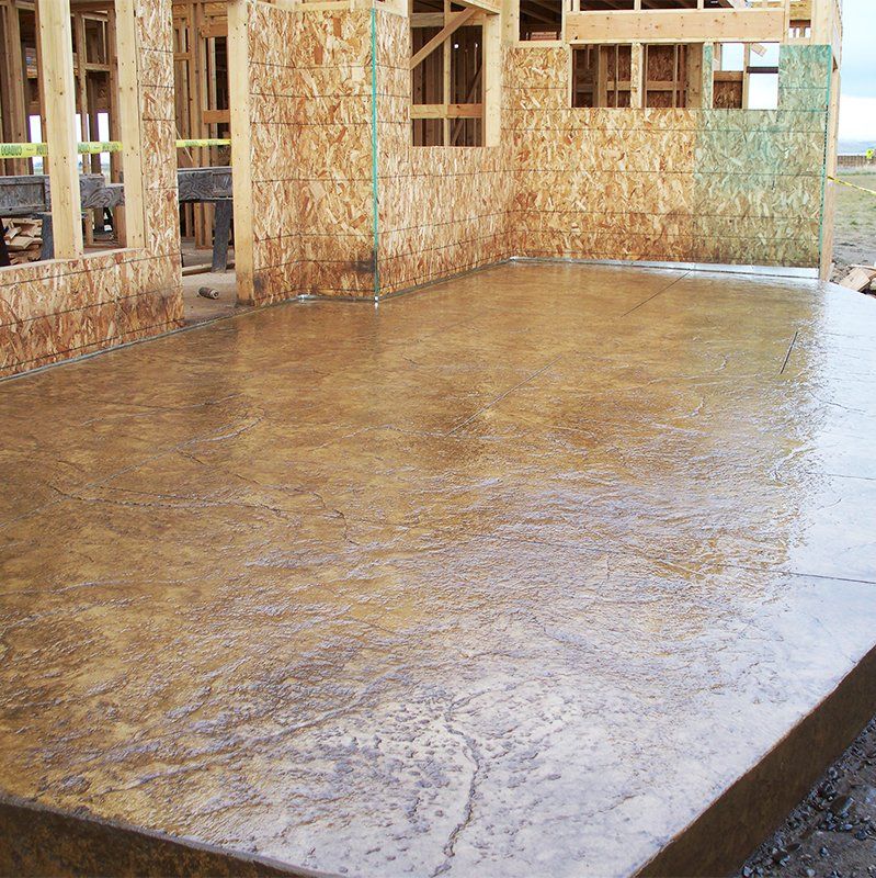 A concrete floor in front of a building under construction