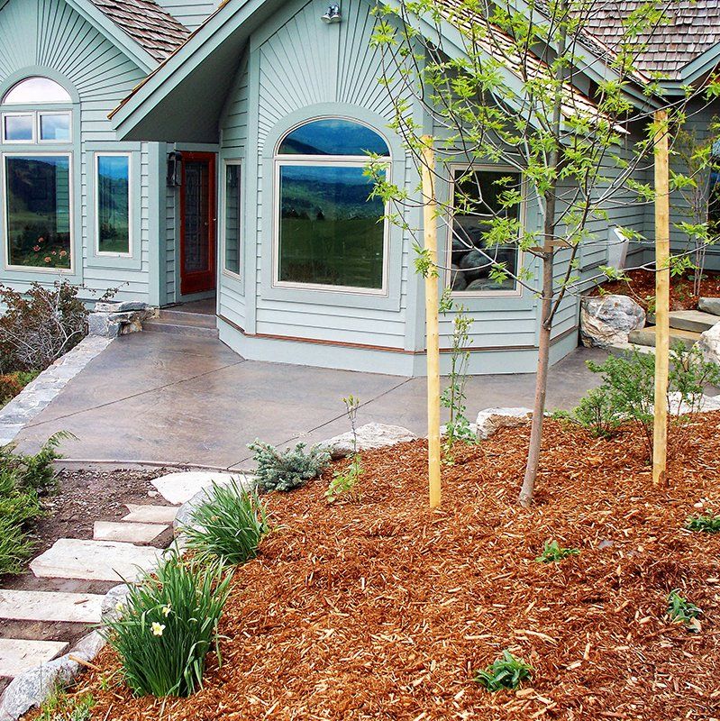 A house with a lot of mulch in front of it
