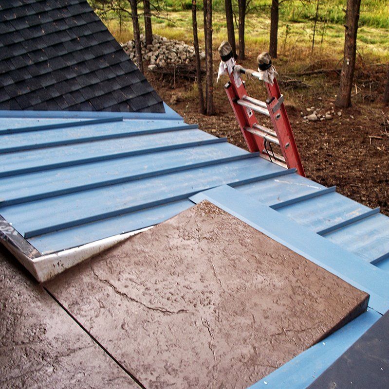 A ladder is sitting on top of a blue roof