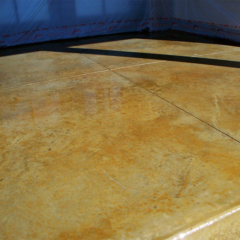 A close up of a concrete floor with a shadow on it.