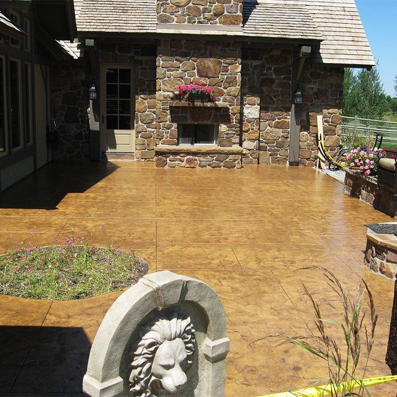 A statue of a lion in front of a stone house