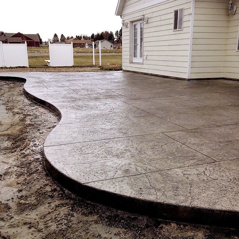 A house with a concrete patio in front of it