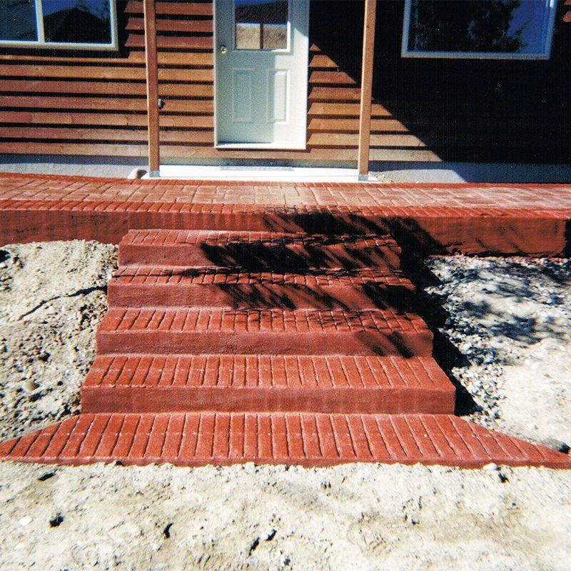 A set of red brick steps leading up to a wooden house