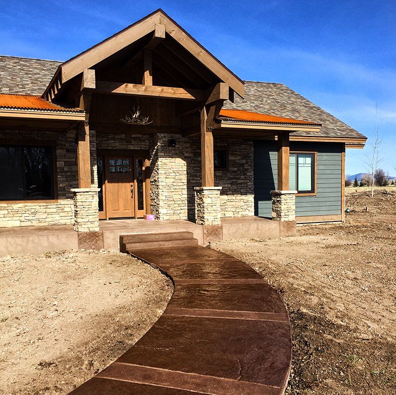 A house with a concrete walkway leading to it