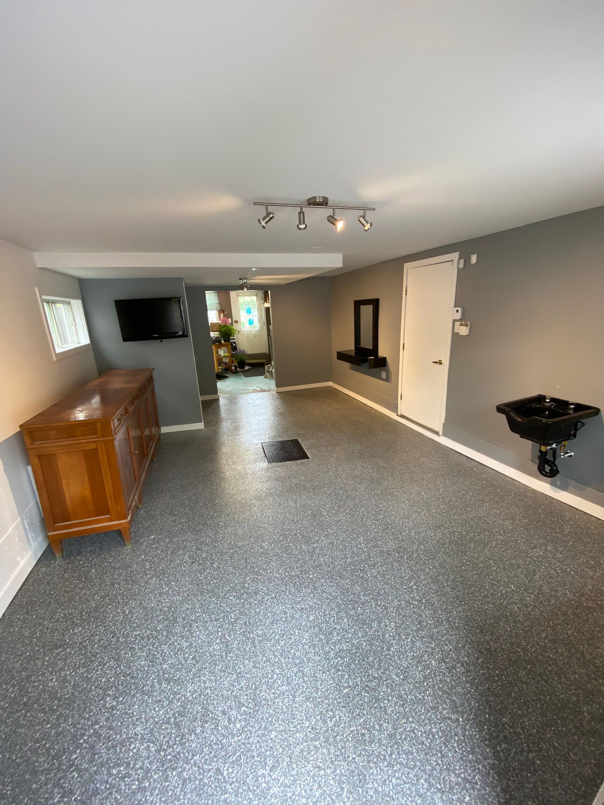 Une grande pièce avec une commode et un lavabo dedans.