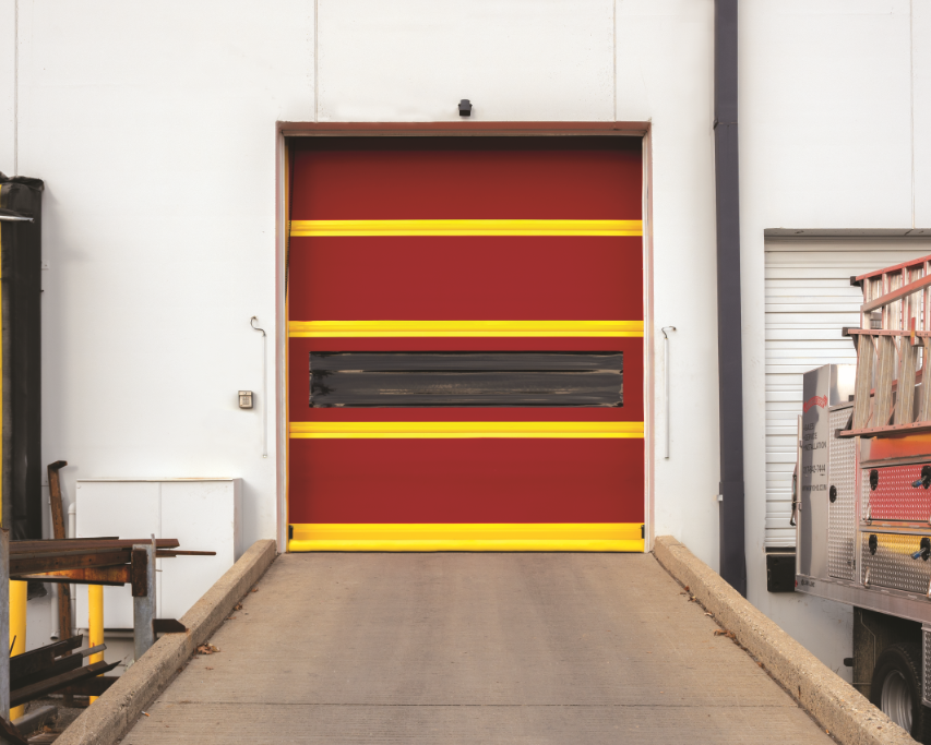 A red door with yellow stripes is open in a warehouse
