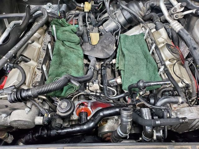 A close up of a car engine with green cloths on it
