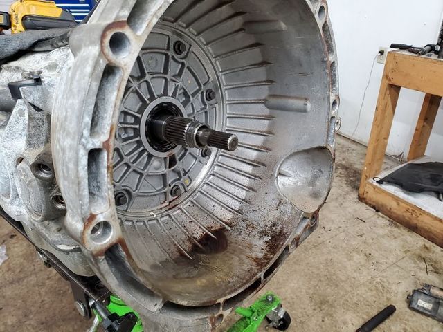 A close up of a car engine with the clutch removed