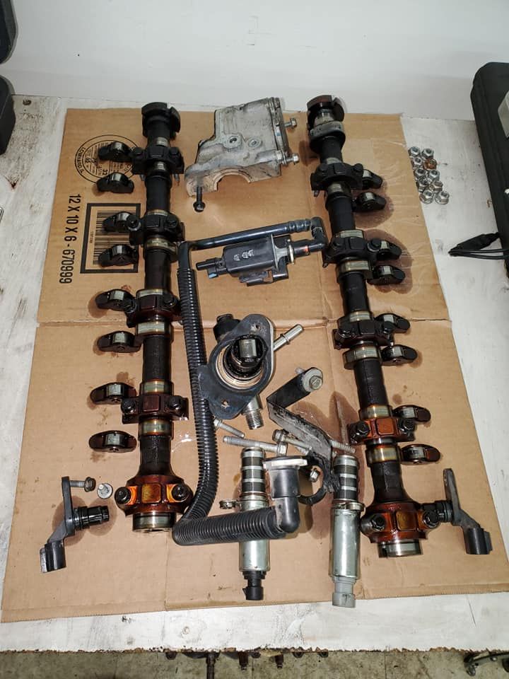 A bunch of parts are sitting on top of a cardboard box.