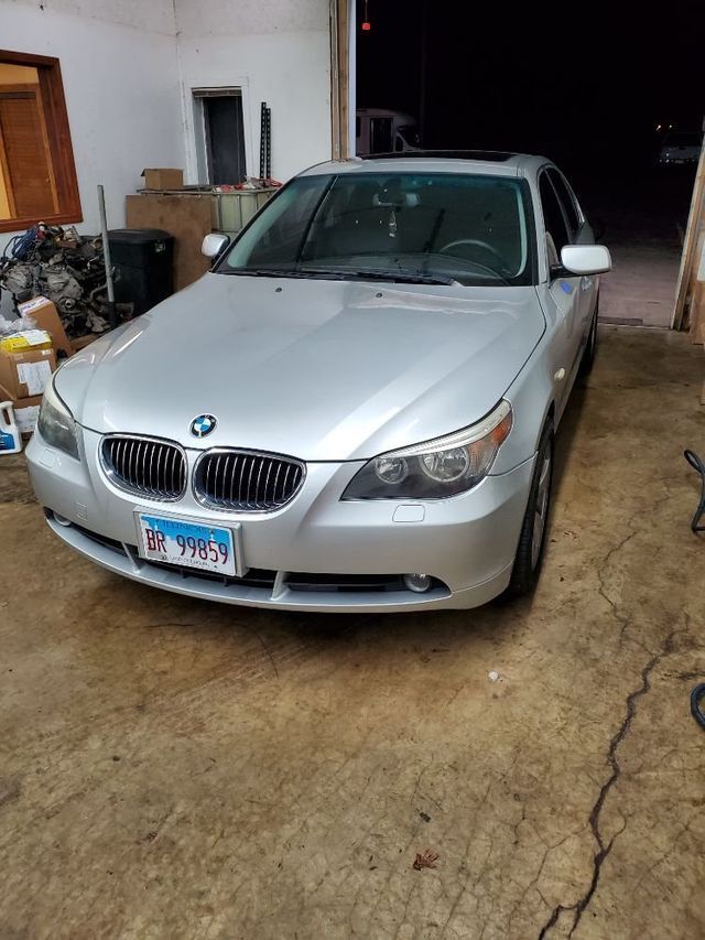 A silver bmw is parked in a garage.
