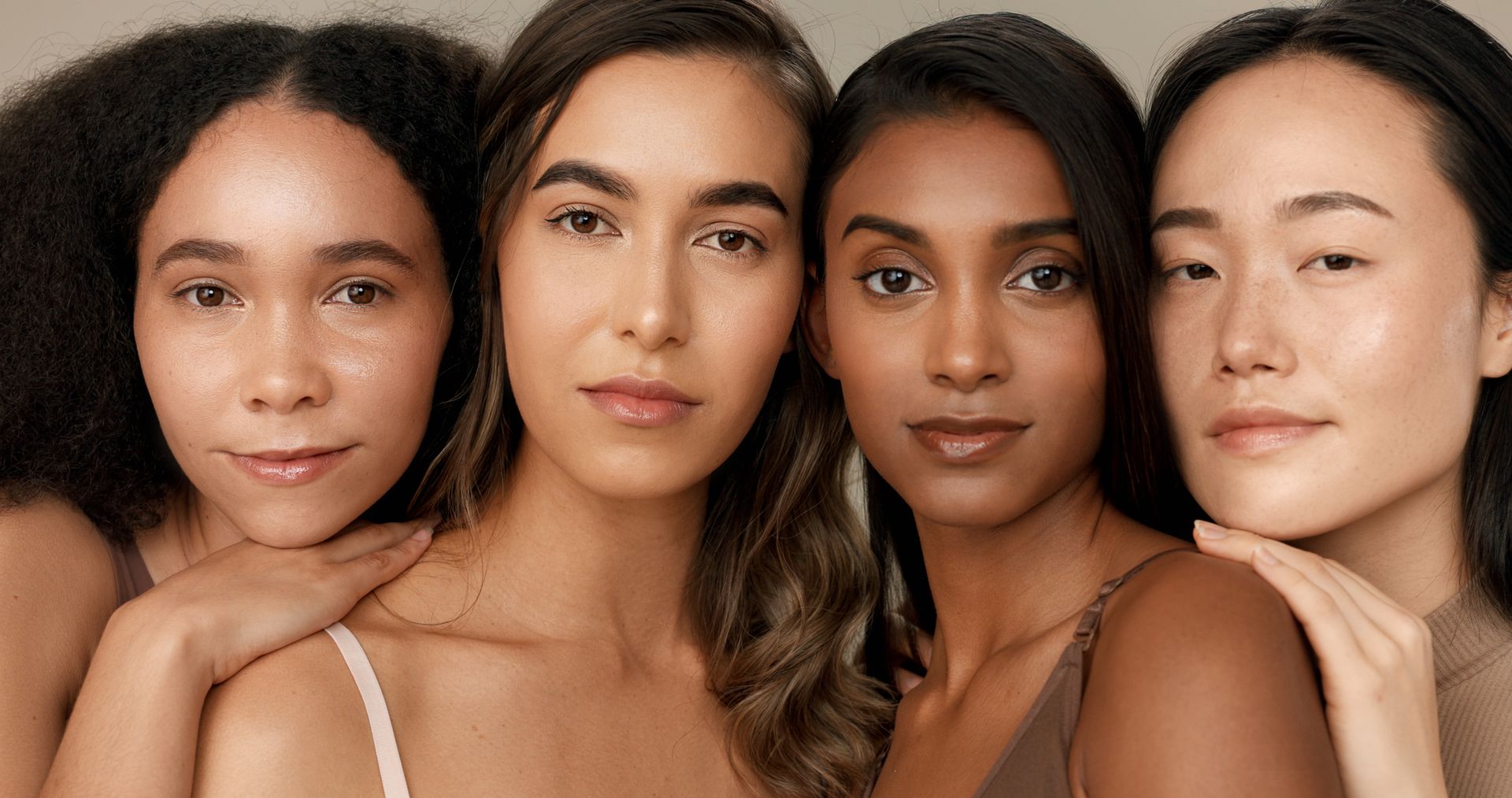 A group of women of different races are posing for a picture together.