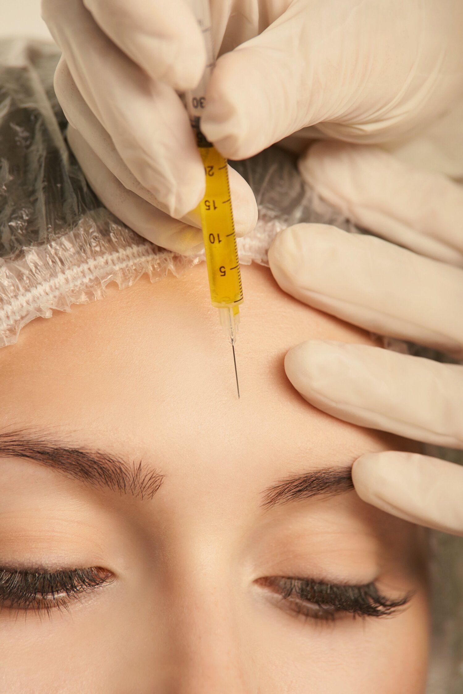 woman holding cosmetic injection needle closeup