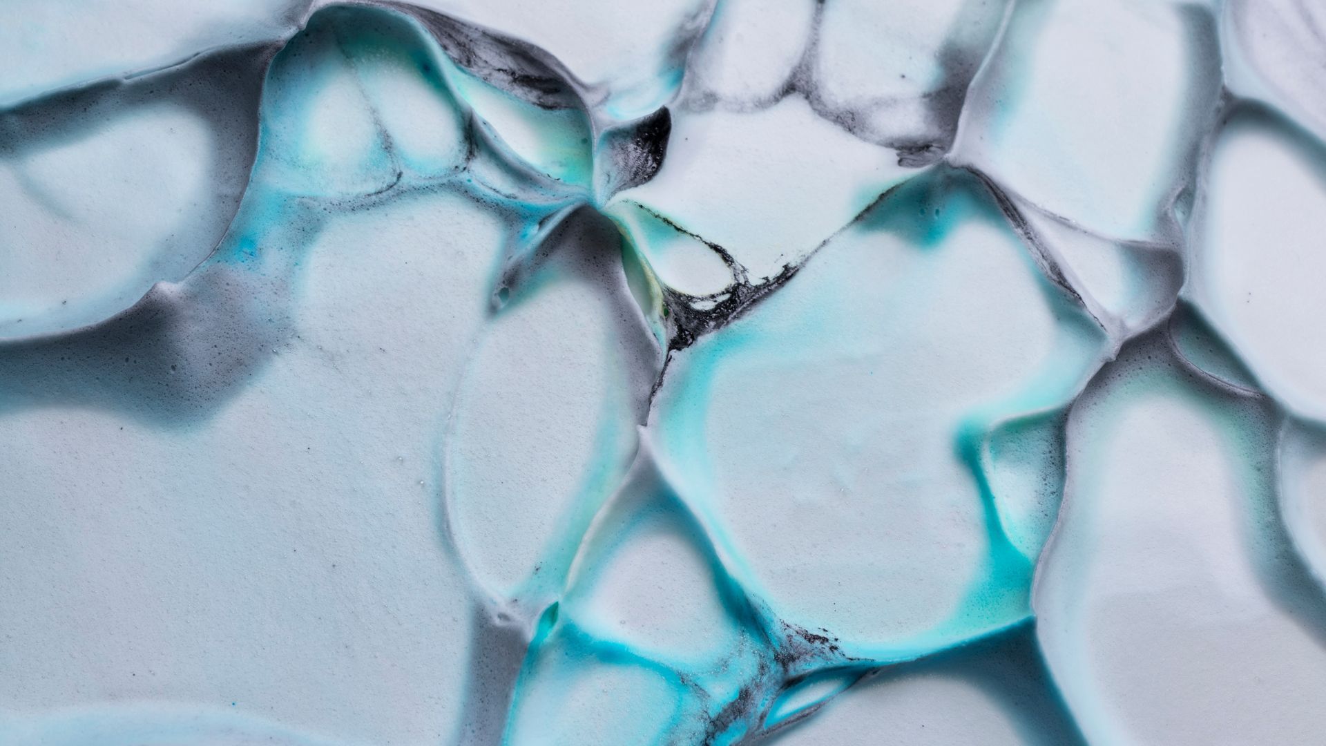 A close up of a blue and white painting on a white surface.