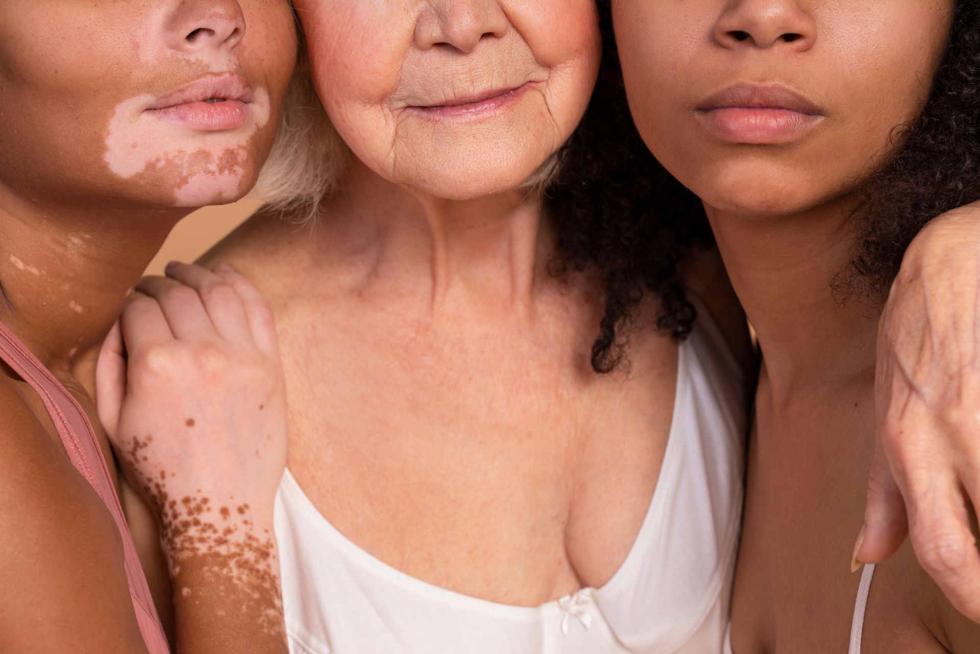 Three women with different skin types are posing for a picture together.