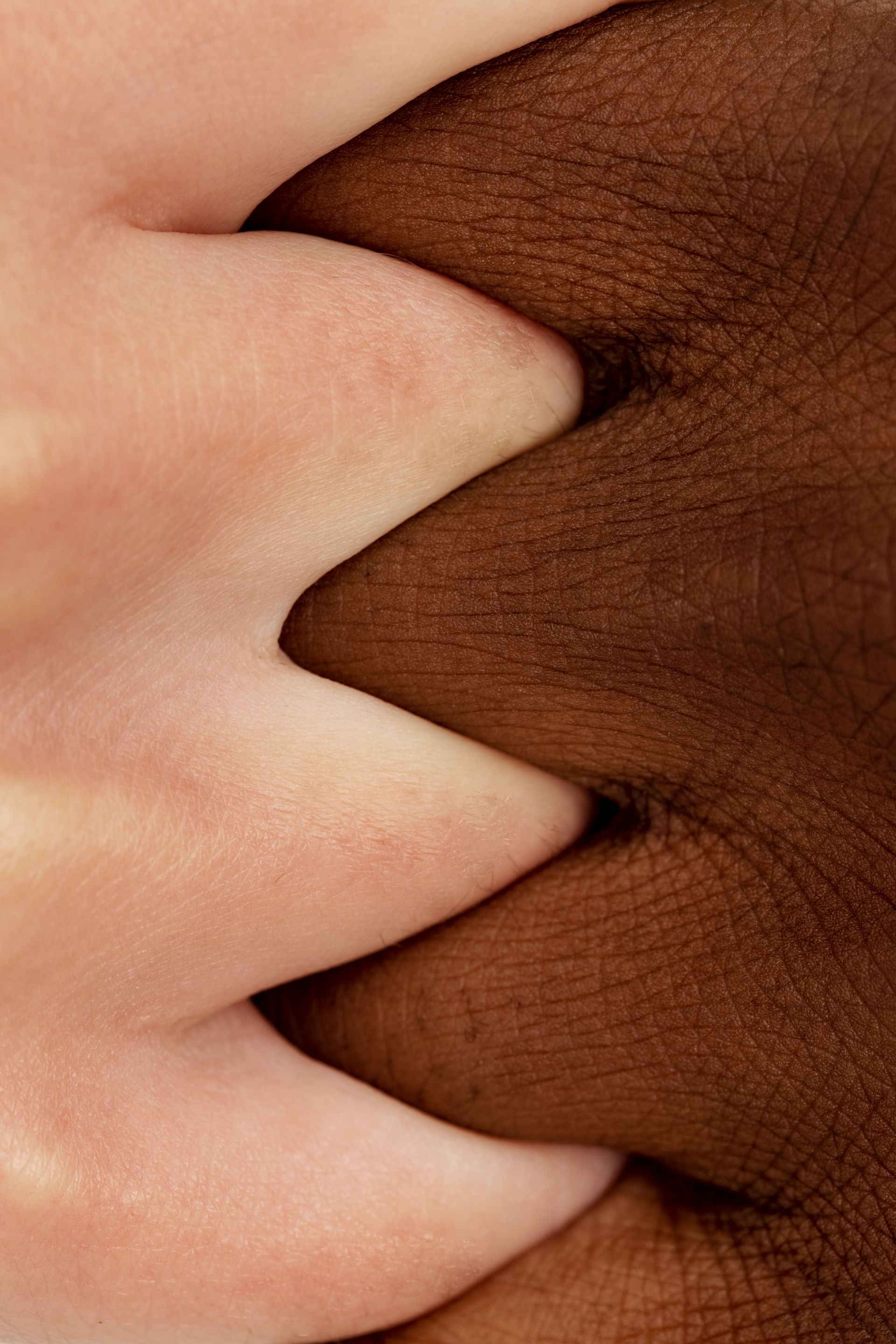 A woman is touching her face with her hand on a white background.