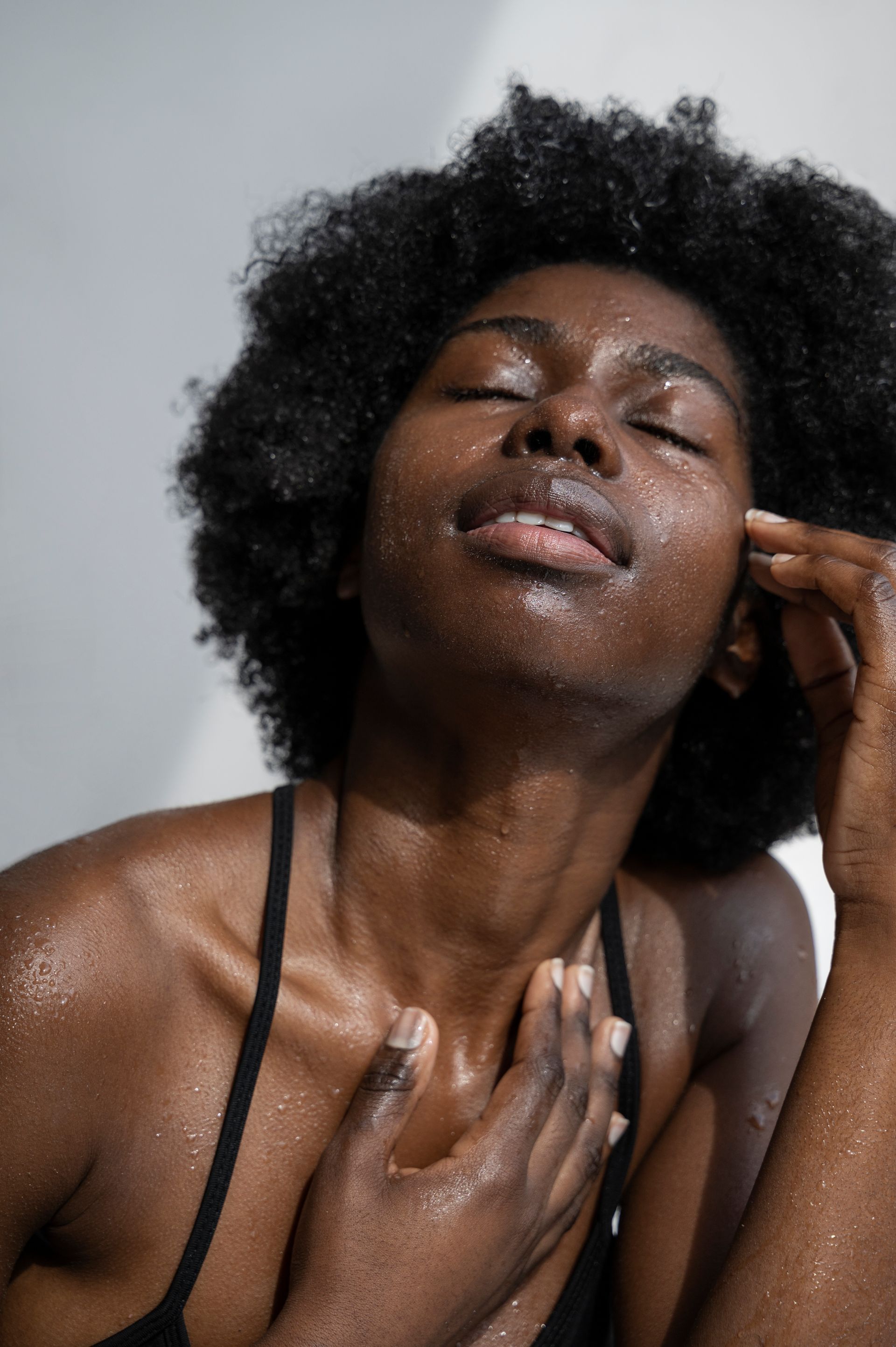 A close up of a woman 's face with her eyes closed.