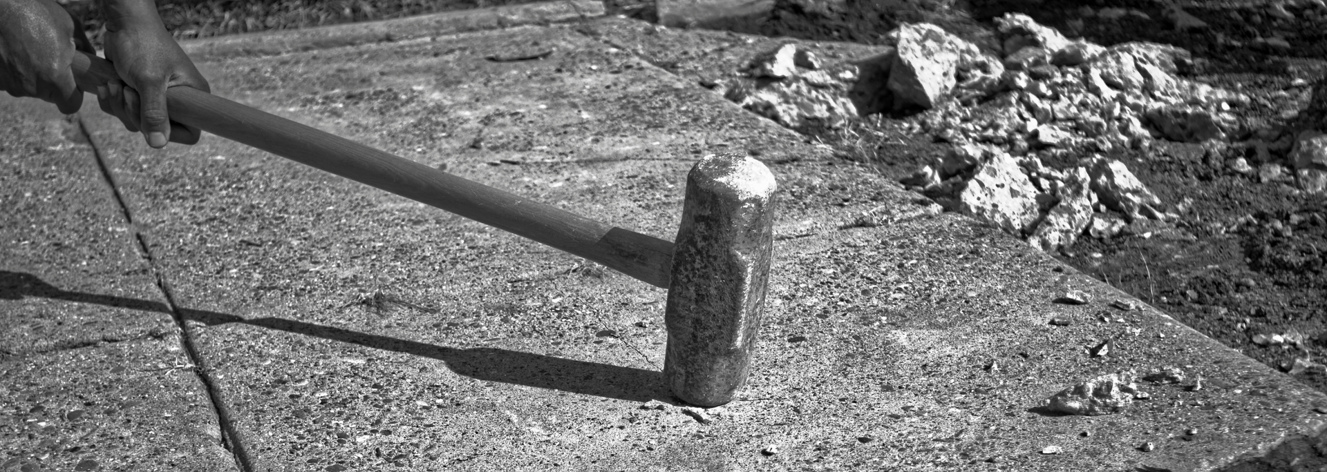 Picture of a nut being cracked by a sledgehammer