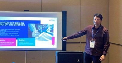 Lotwork representative presenting ring scanner technology and ergonomic ROI at a warehouse innovation seminar.