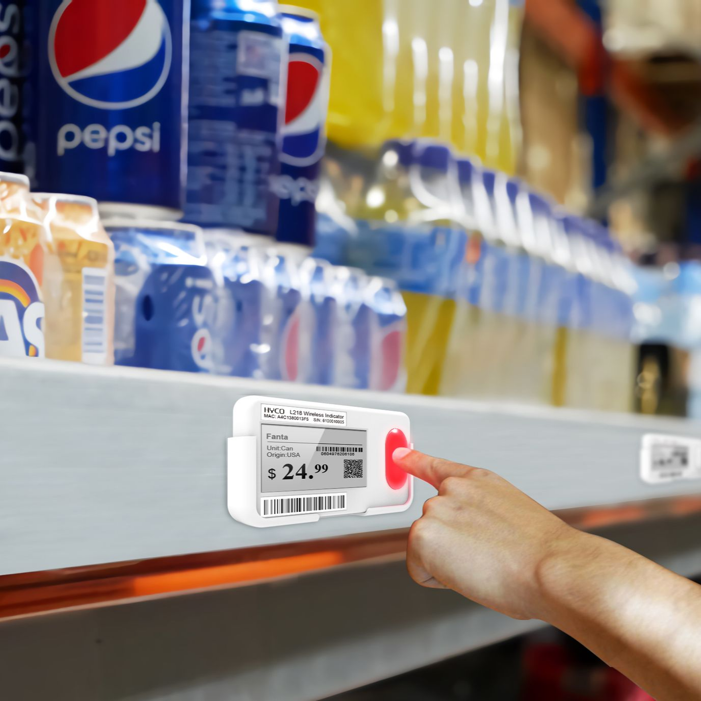 Hand touching a digital price tag(wireless light tag) in a store, next to cans of Pepsi.