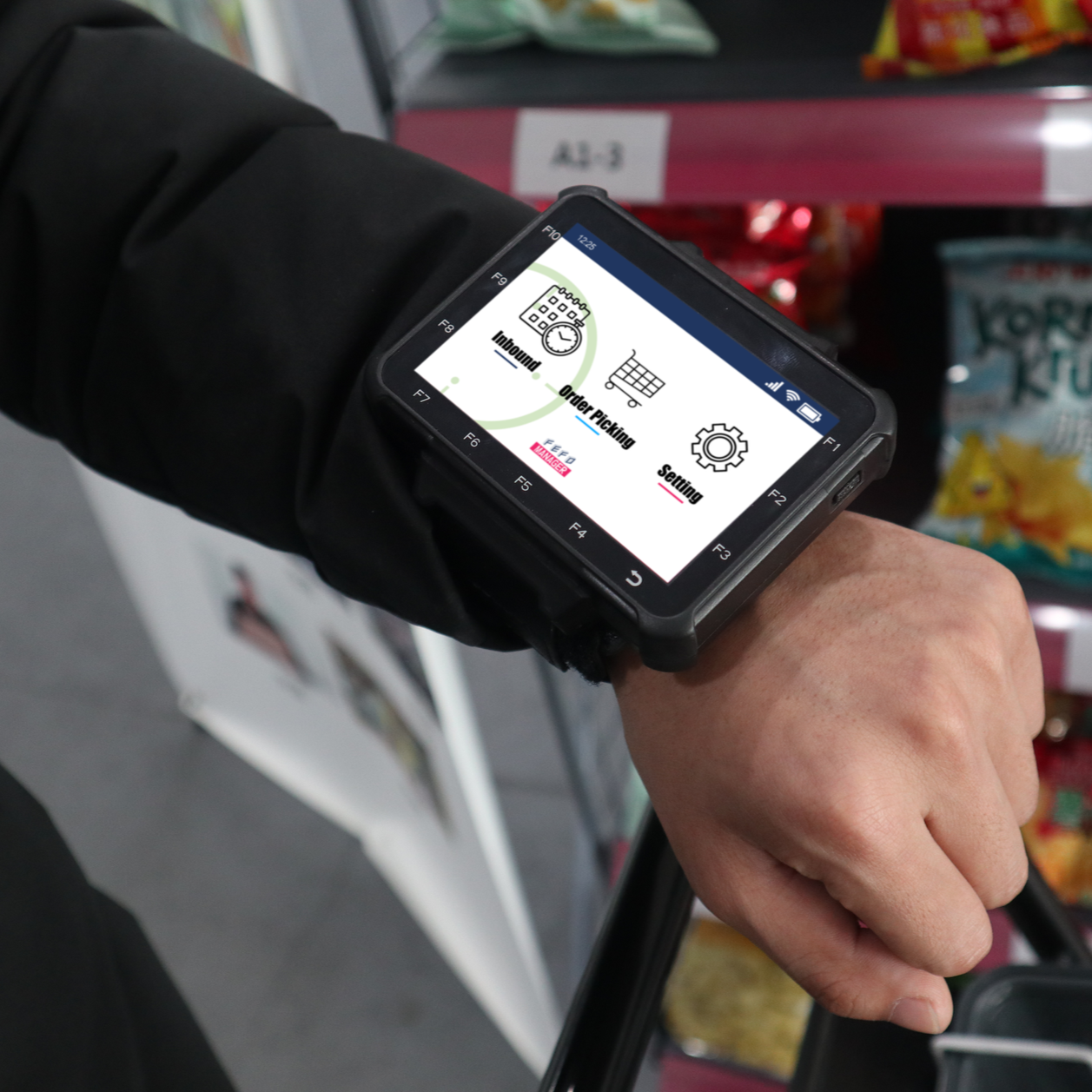Person's wrist wearing a wearable computer displaying icons, grocery store background.