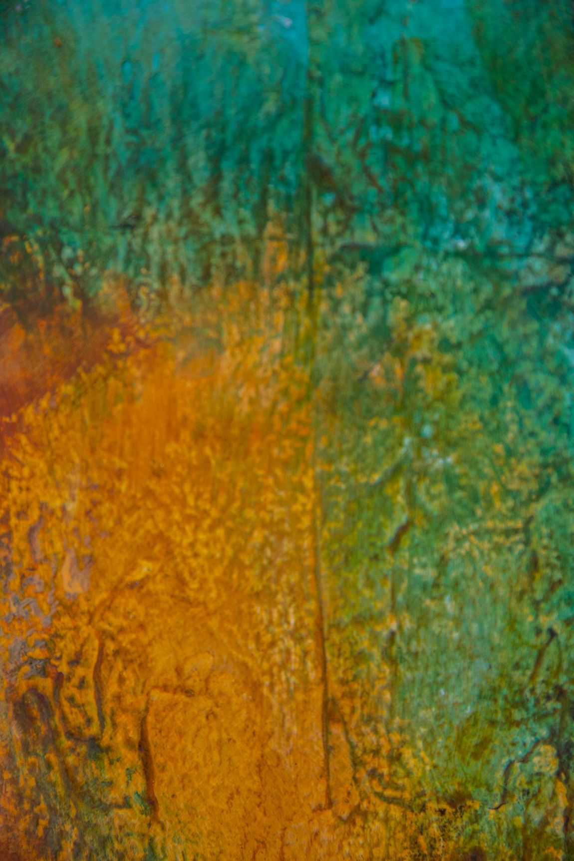 Abstract texture featuring blended patches of teal, green, and deep gold with organic, weathered patterns.