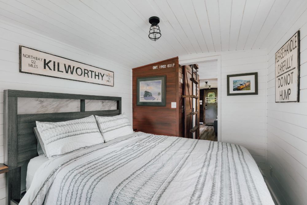 A bedroom with a bed and a sign on the wall that says kilworthy.