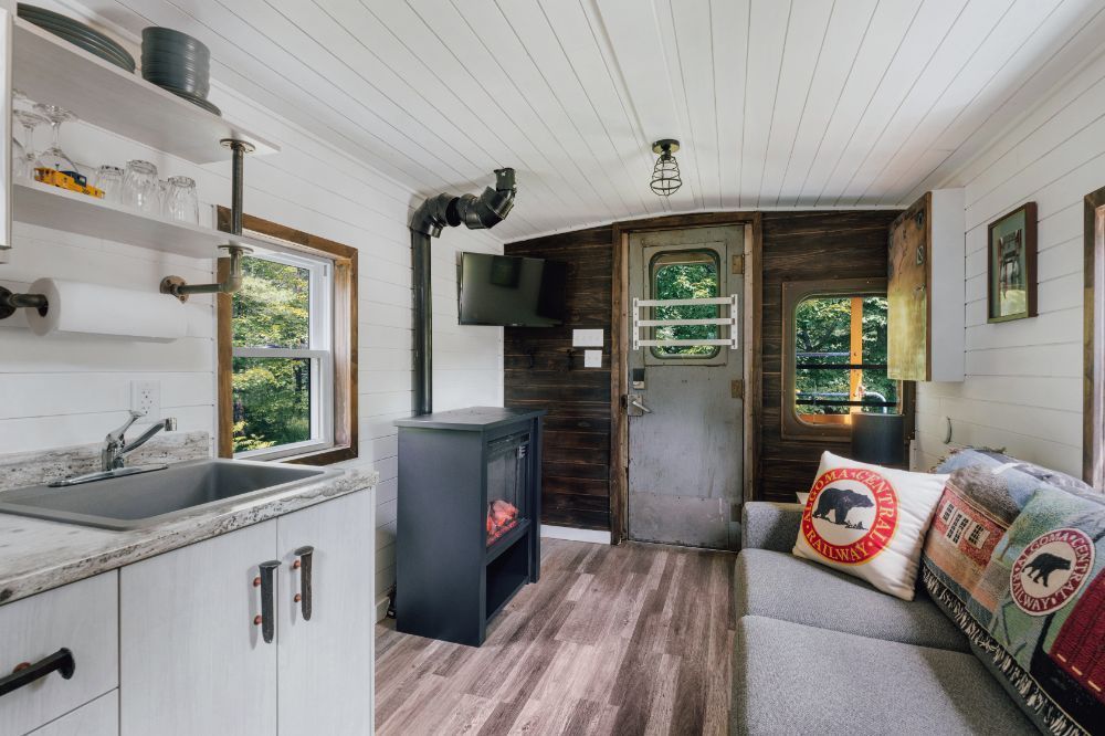 A living room with a couch , sink , and fireplace.