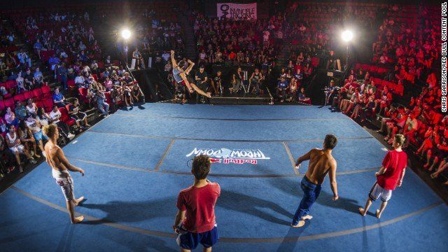 Tricking athletes competing in a large arena battle circle during a live international tricking event
