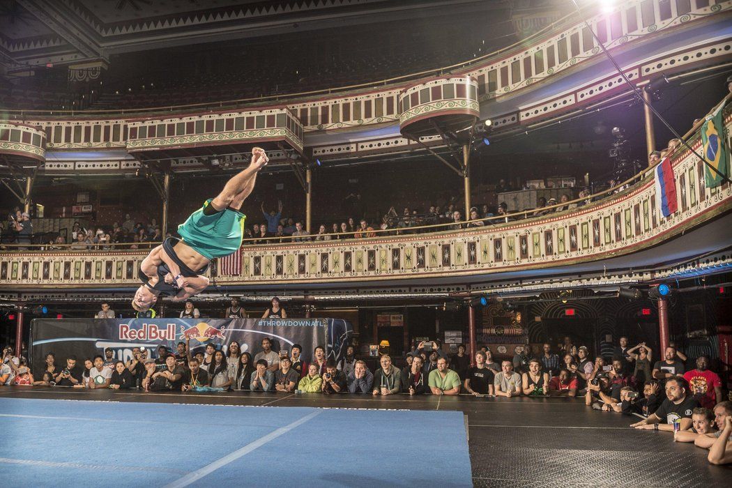 Tricking athlete performing a high aerial flip on stage during a live Red Bull tricking competition event