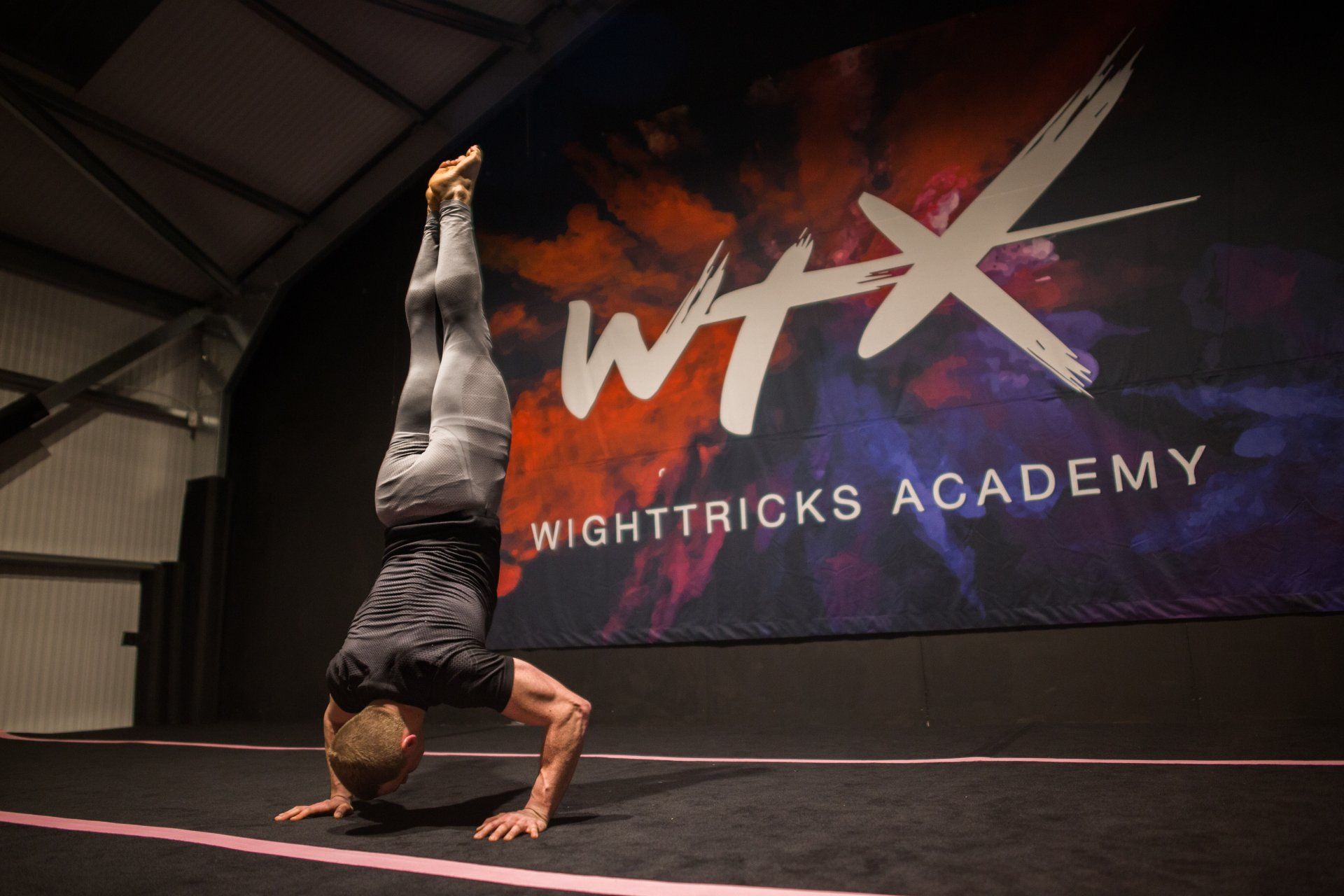 man doing a controlled handstand with bent arms