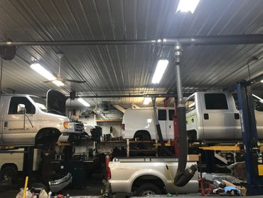 A garage filled with trucks and vans being worked on | North County Service Center