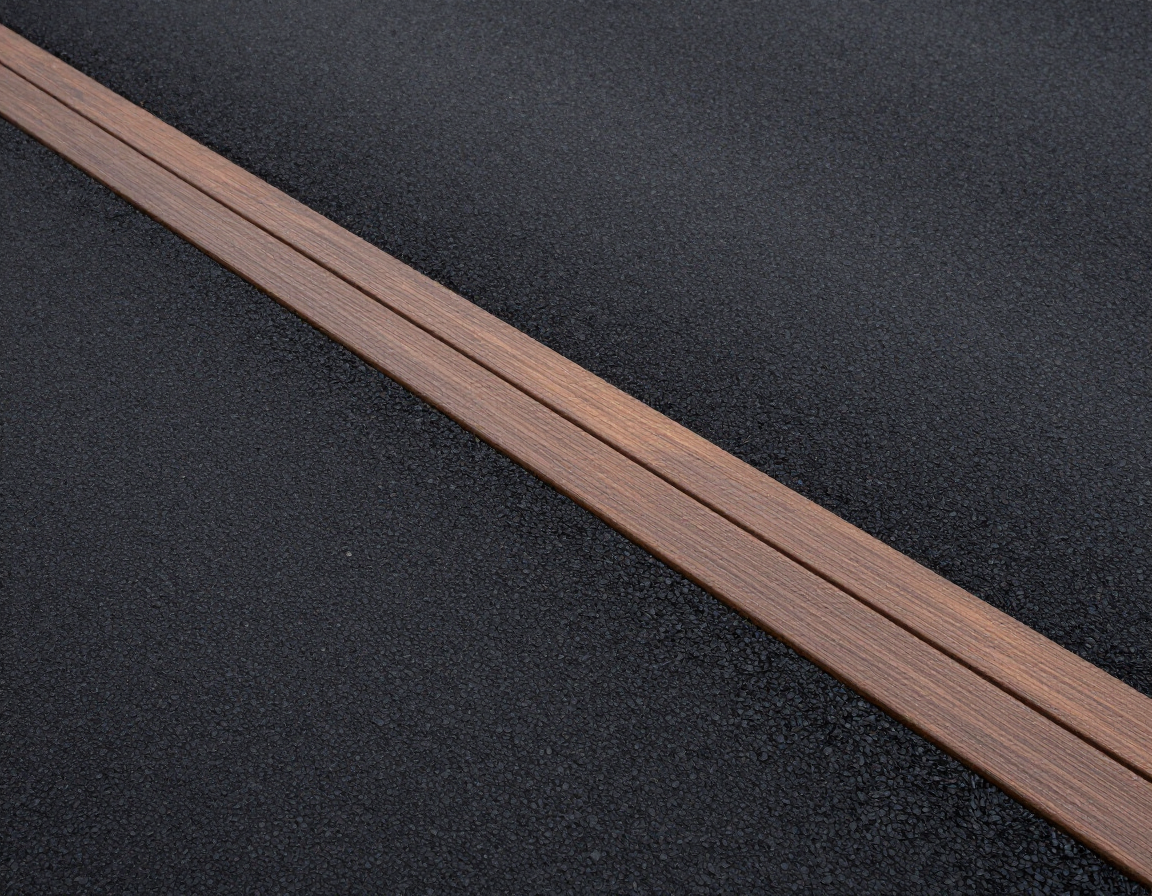 A perfectly smooth residential asphalt driveway showing the finished texture and clean edges.