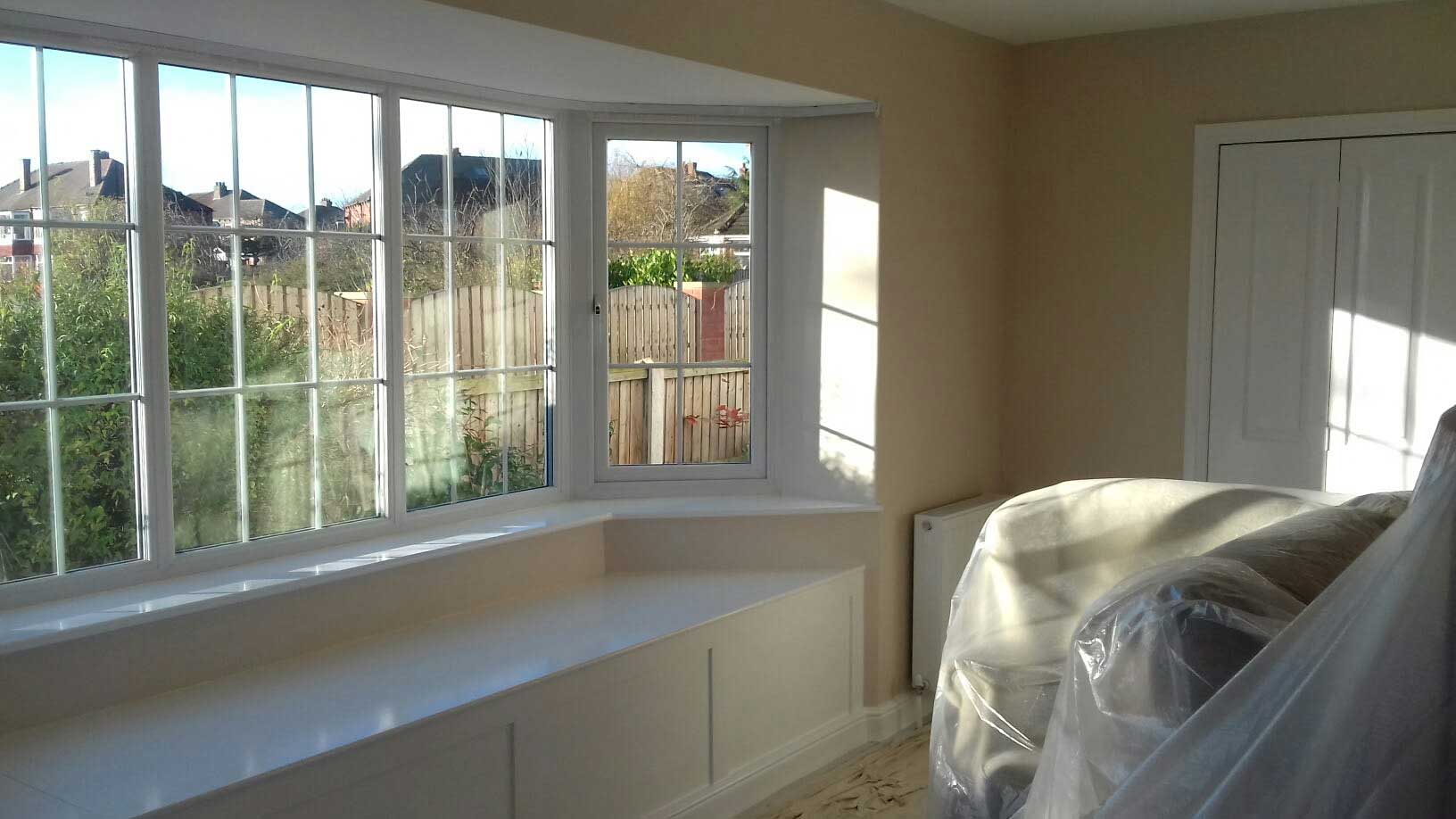 room being decorated with large windows