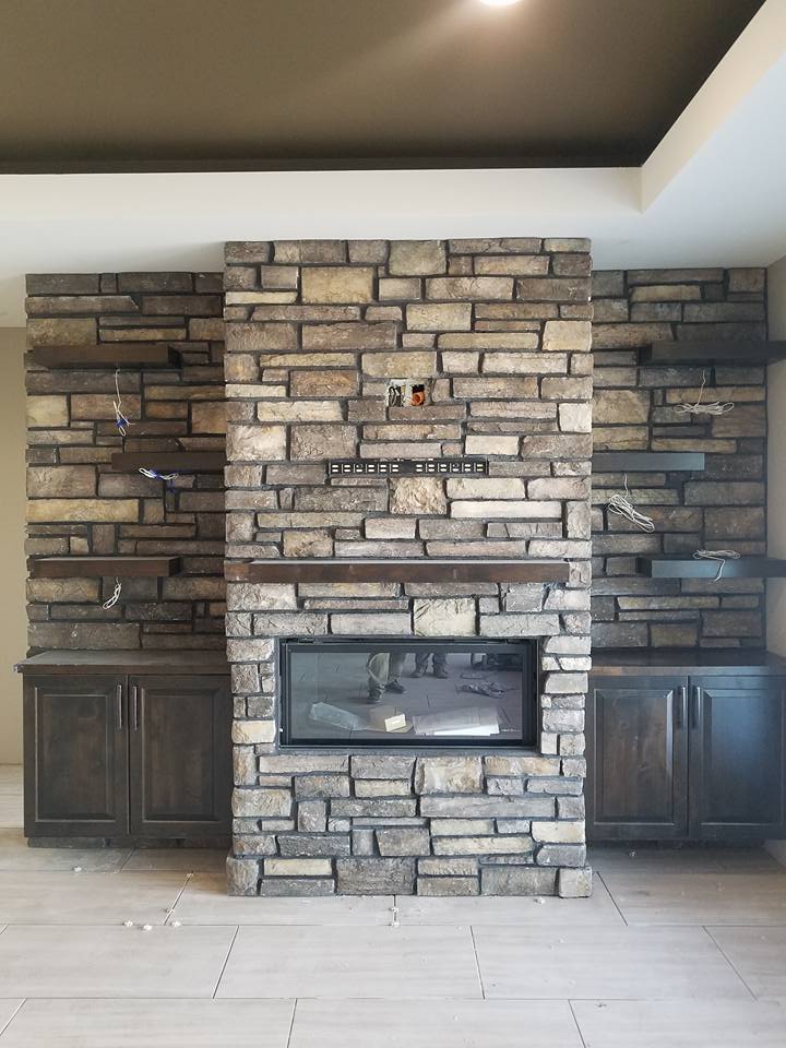 Stone Wall With Fireplace, Cabinet and Floating Shelves