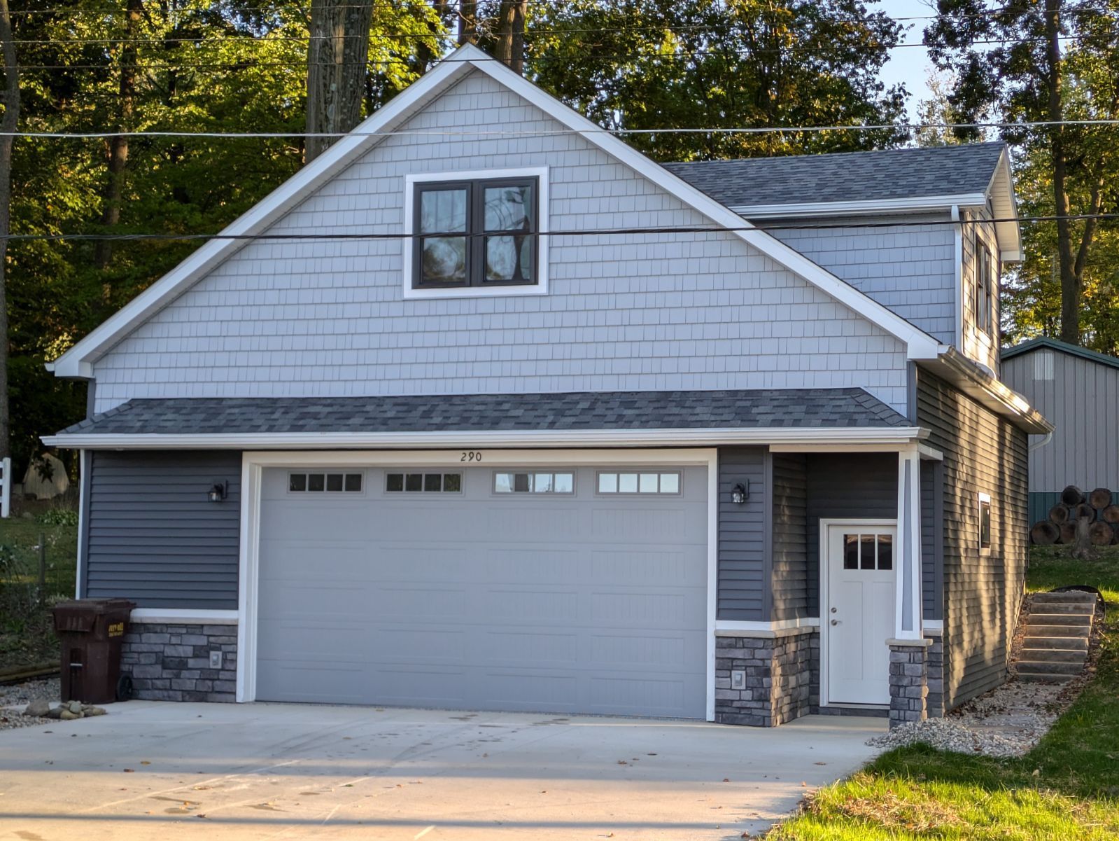 A house with a garage and a gray garage door