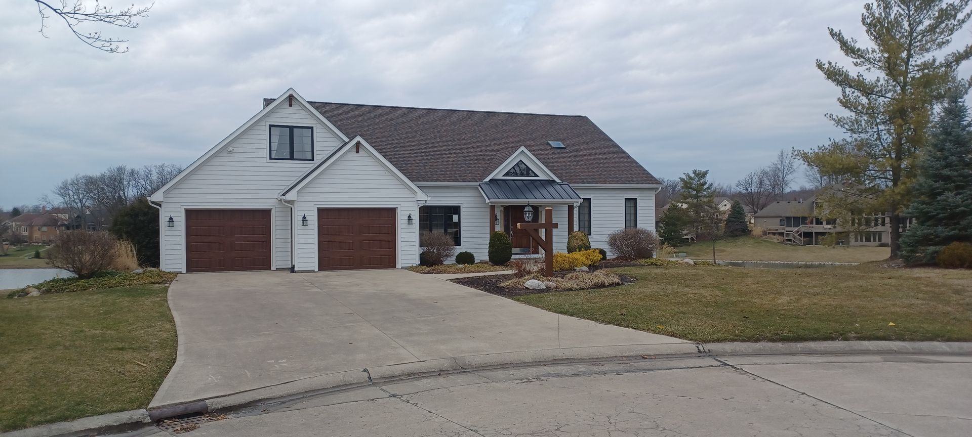 A Man Is Sitting on Top of A Tiled Roof | Shelbyville, IN | SL Construction