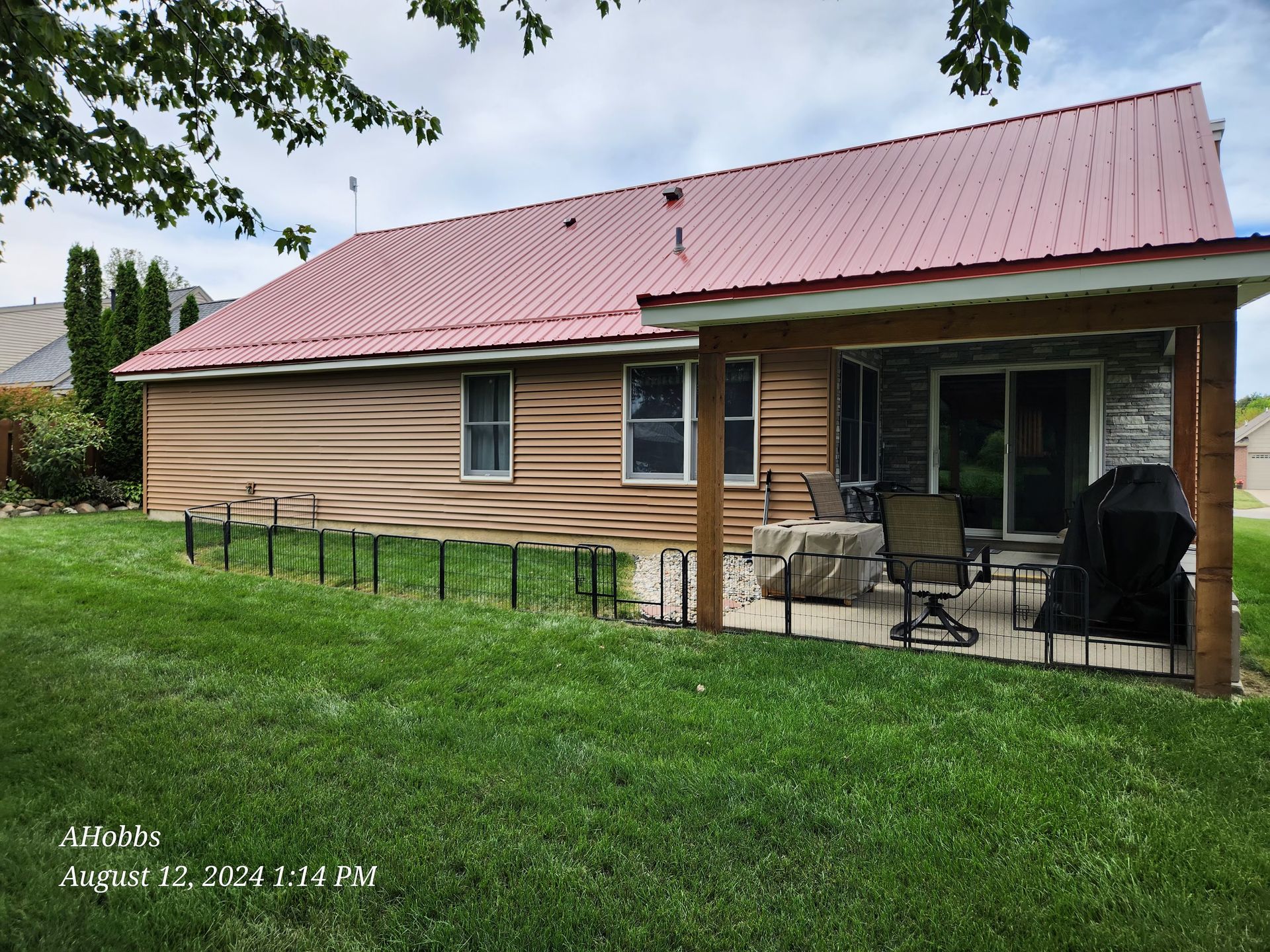 The back of a house with a red roof