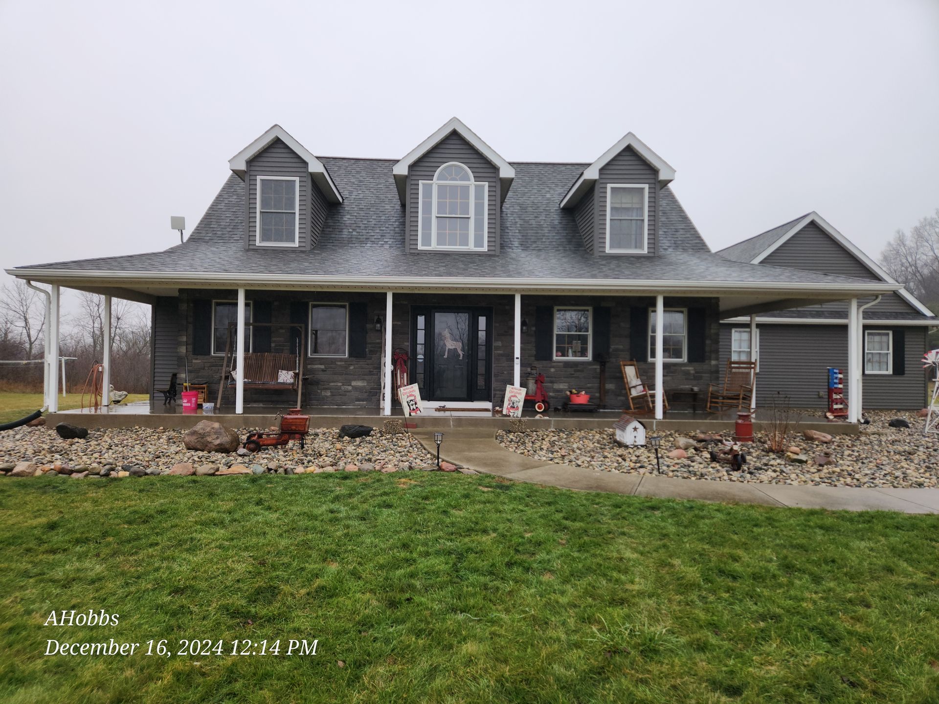 A large house with a porch and a lot of windows