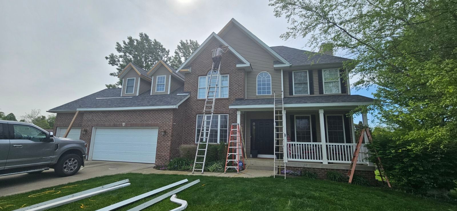 A Patio with Wicker Furniture and A Fire Pit in Front of A Swimming Pool | Shelbyville, IN | SL Construction