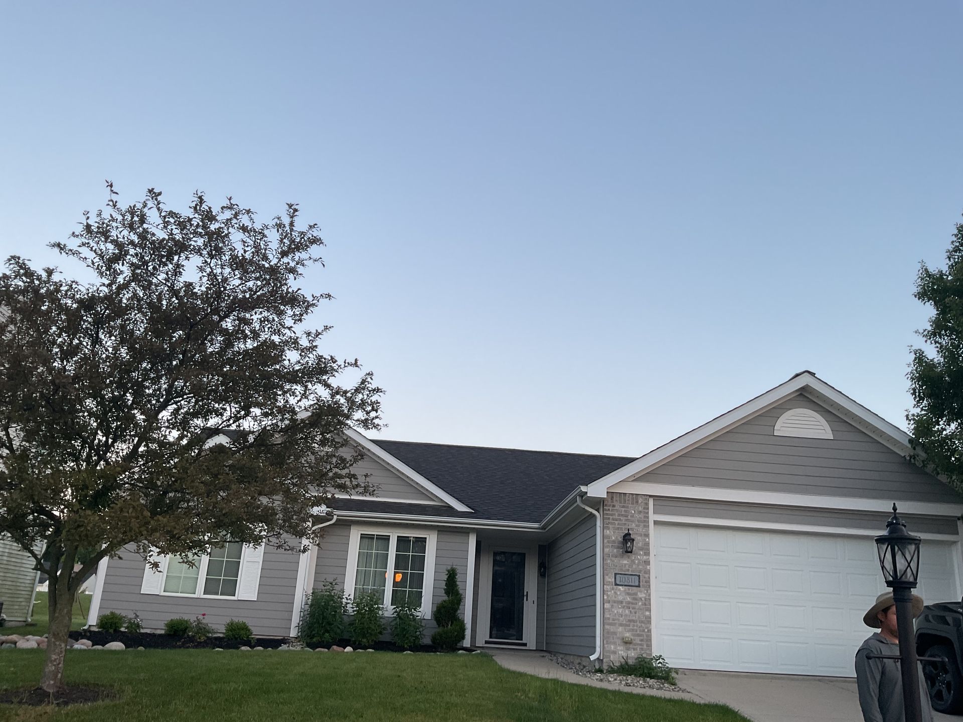 A house with a car parked in front of it