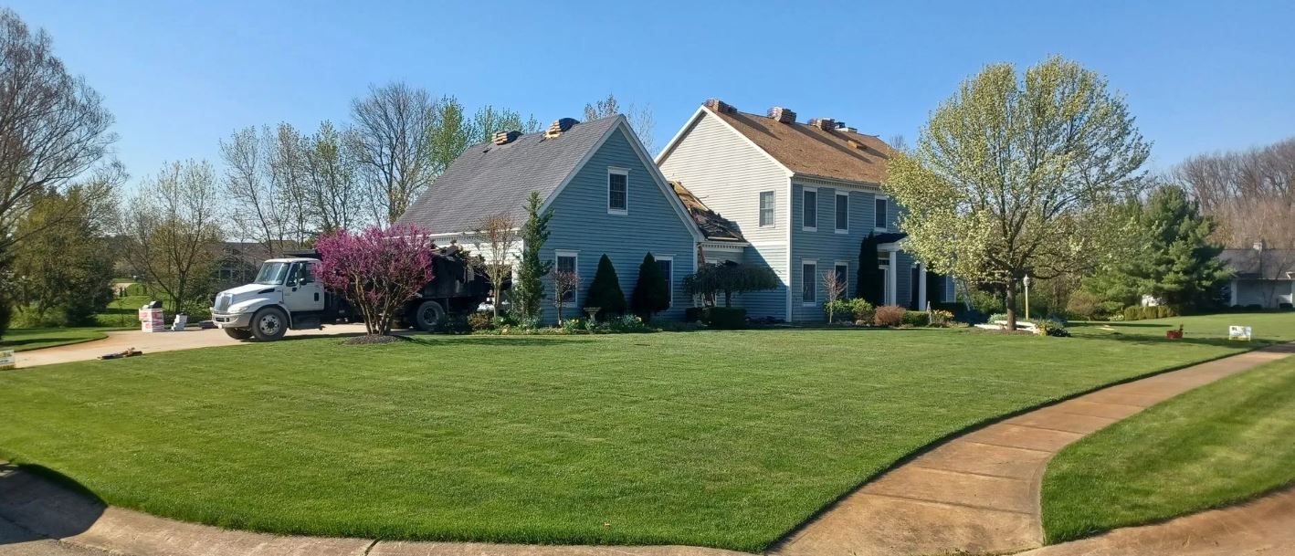 A Man Is Working on The Roof of A House | Shelbyville, IN | SL Construction