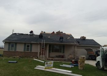 Two Construction Workers Are Working on The Roof of A Building | Shelbyville, IN | SL Construction