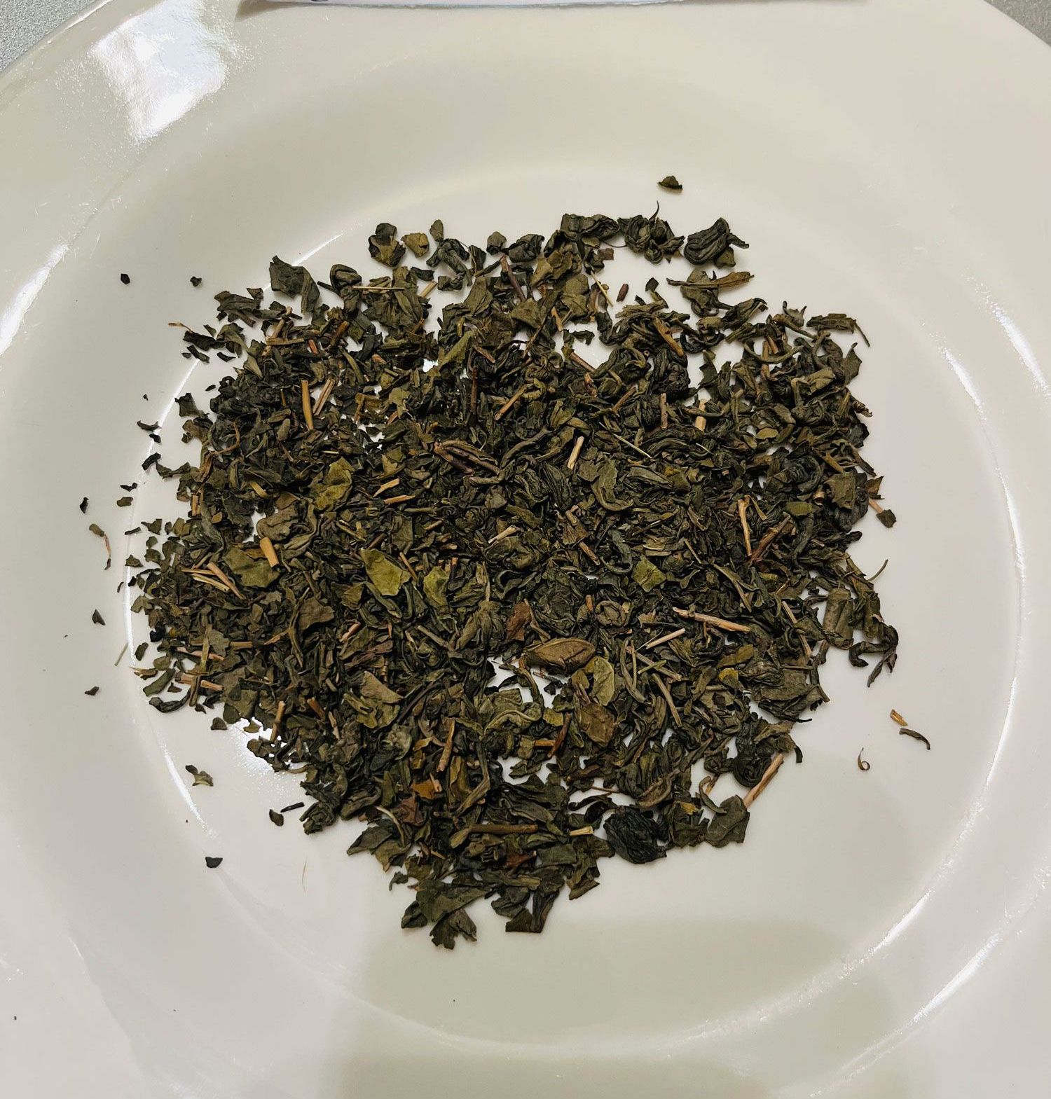 This extra-fine Pinhead Gunpowder tea is grown in China. Dating back to the Tang Dynasty. This tea gets its name from its resemblance to gunpowder—the young green tea leaves are rolled into very small pellets before pan firing. If it helps, pinhead is less grassy than other greens. It’s a great tea for people who find most green teas too bitter or astringent. Gunpowder tea is known for its strong, sweet, and smooth flavor and dark colored brew.
