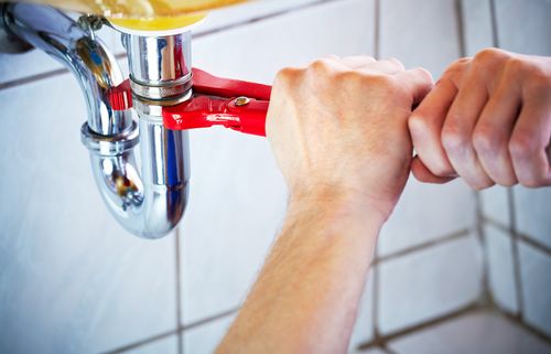 Plumber Hands Holding Wrench — Metairie, LA — A-Perfect Plumbing Inc