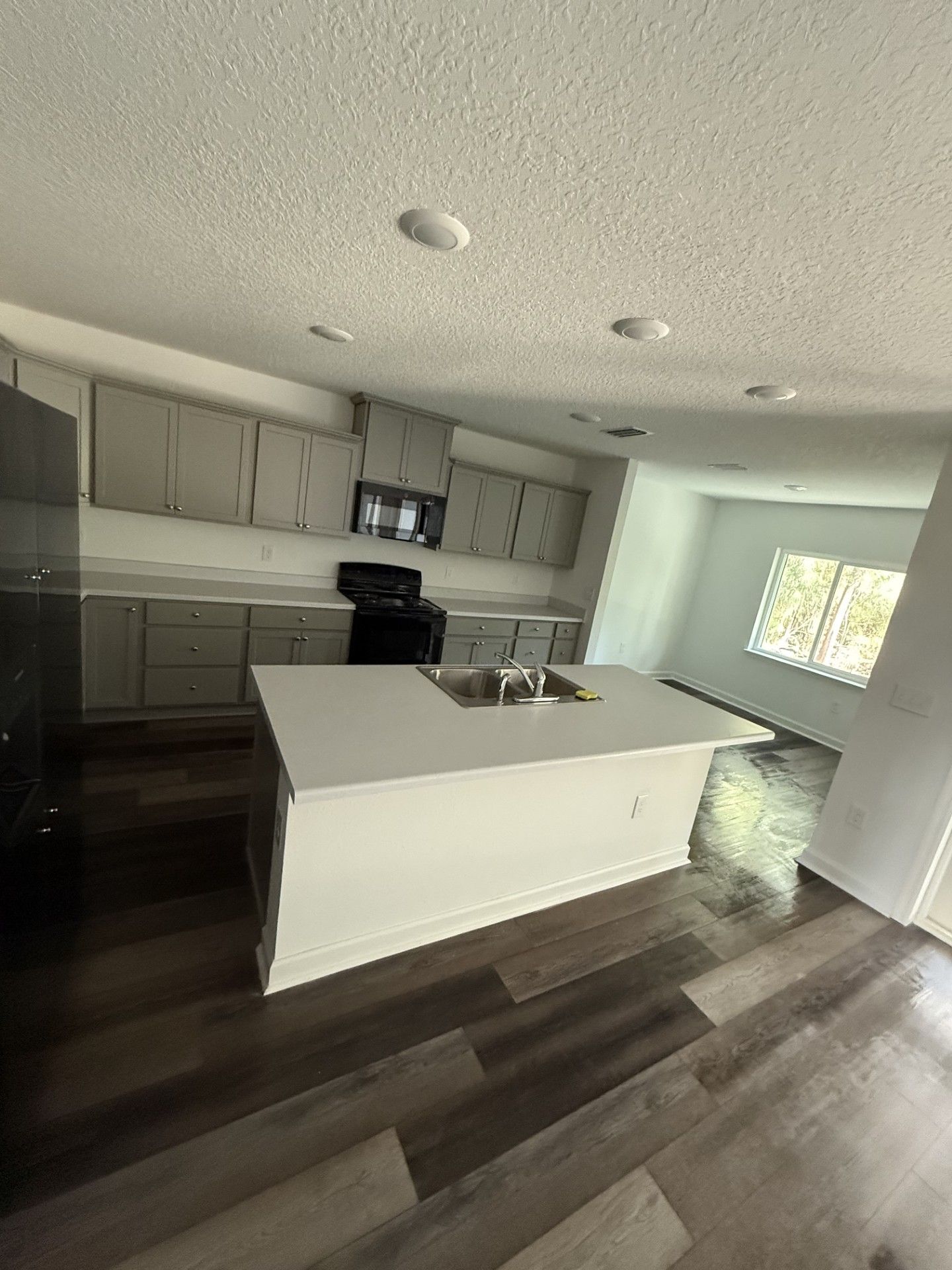 There is a large island in the middle of the kitchen.