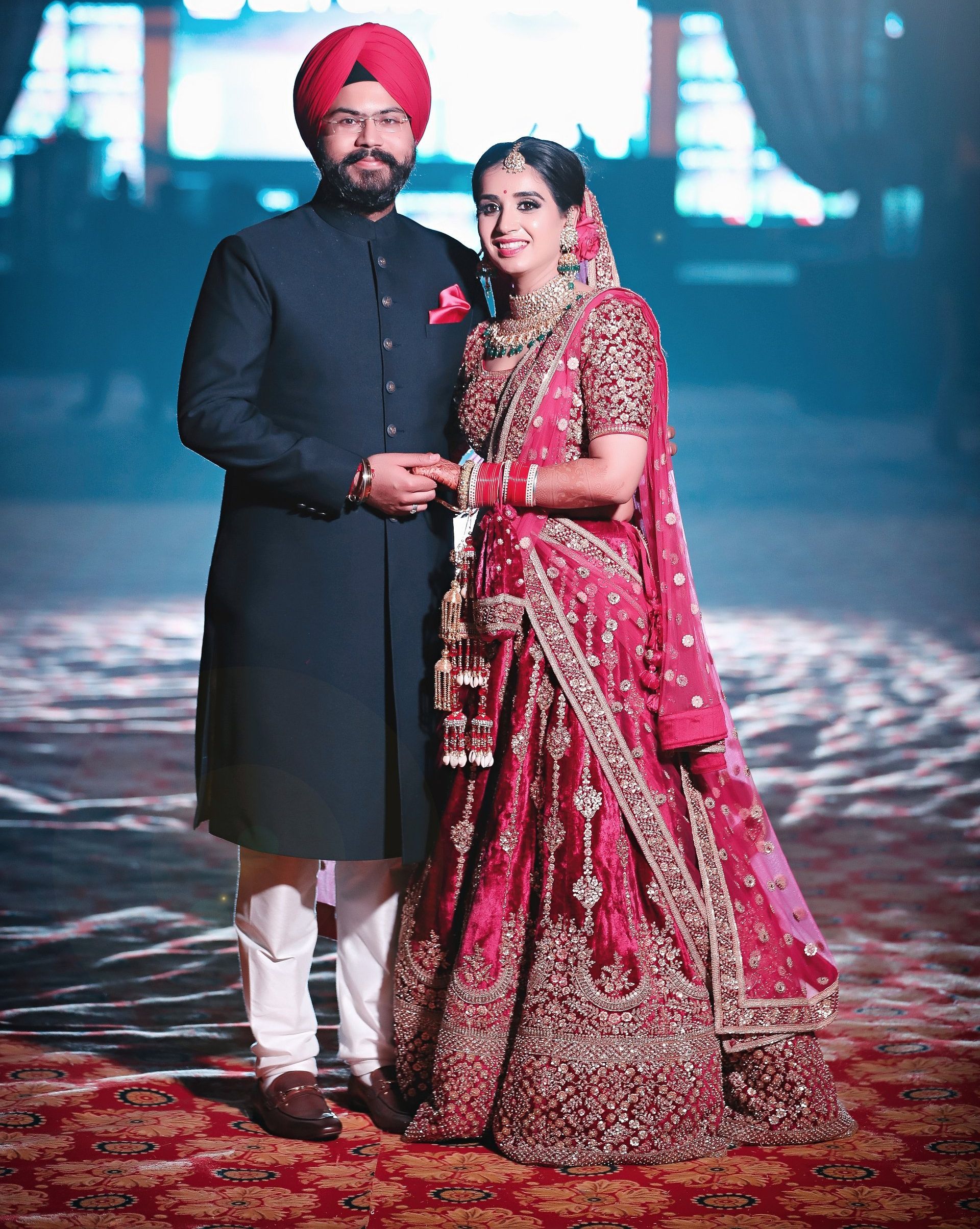 A bride and groom are posing for a picture on their wedding day.