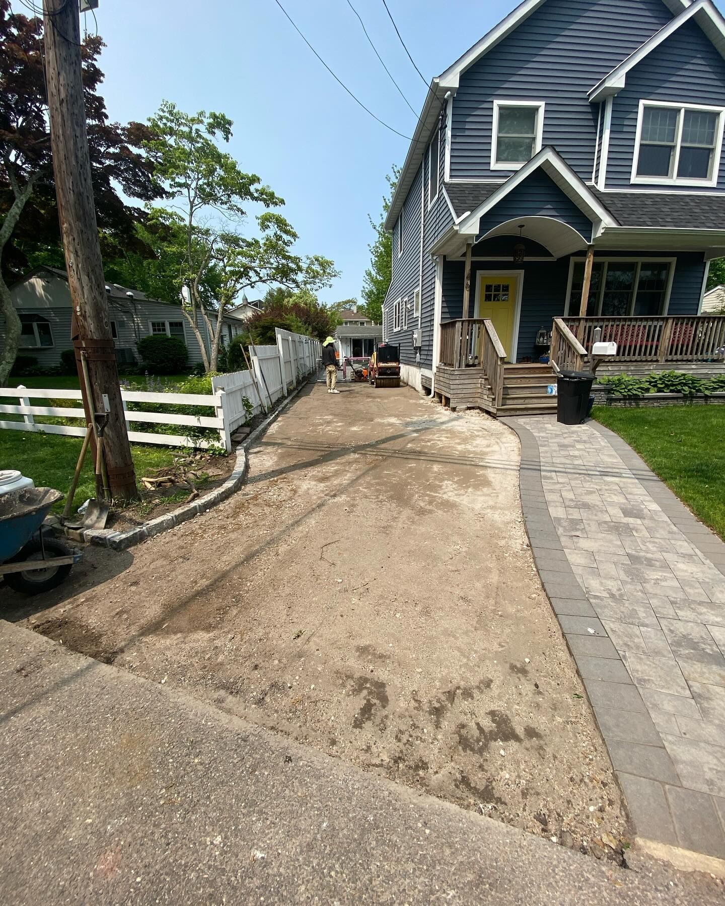 A driveway is being built in front of a house.