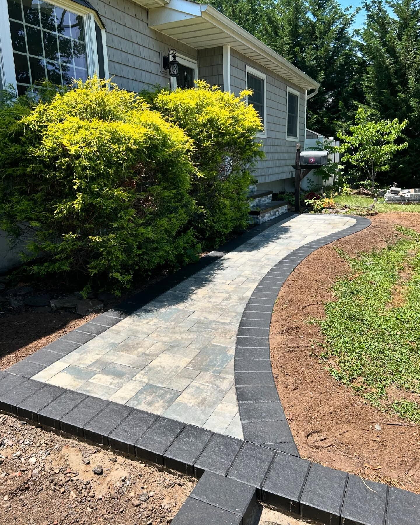 A walkway is being built in front of a house.