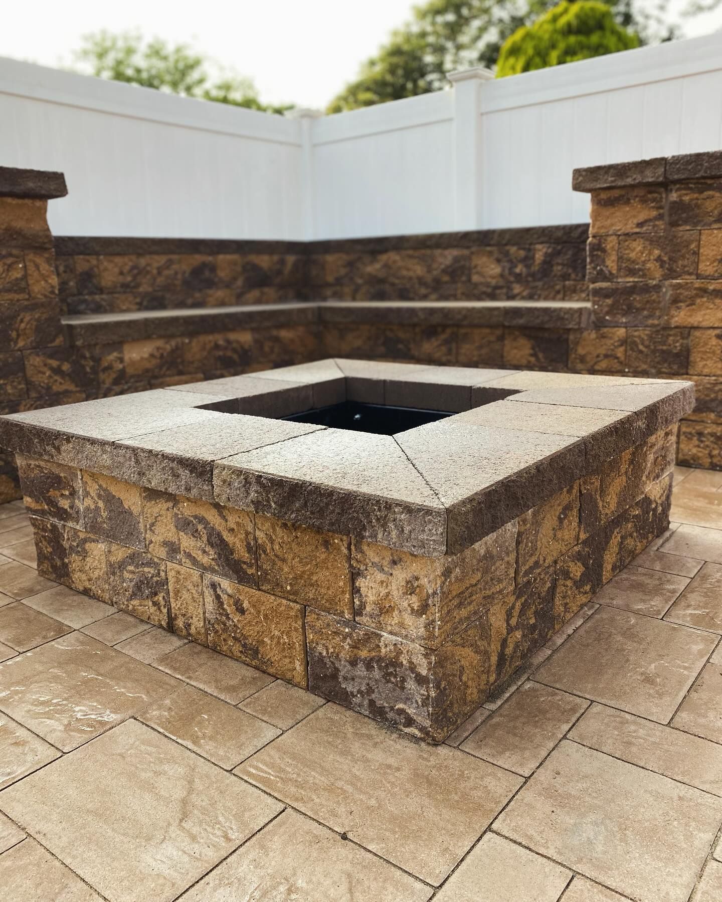 There is a fire pit in the middle of the patio.