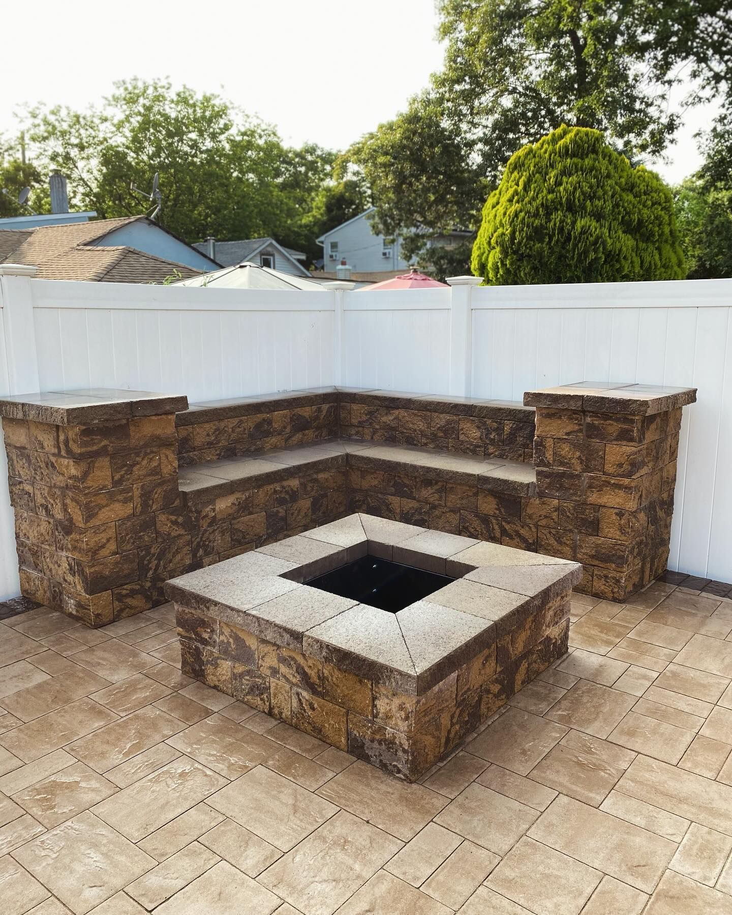 There is a fire pit in the middle of the patio.